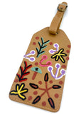 Leather luggage tag with colorful floral embroidery on a white background