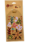 Leather luggage tag with floral designs on a Better World Arts packaging
