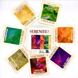 Collection of Serenitea tea bags with various flavors on a white background