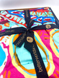 A close-up of the tablecloth gift box tied with a black and gold ribbon.